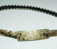 NEAT PREOWNED NARROW METAL & FABRIC FASHION BELT WITH GOLD COLOR LEAF DESIGN