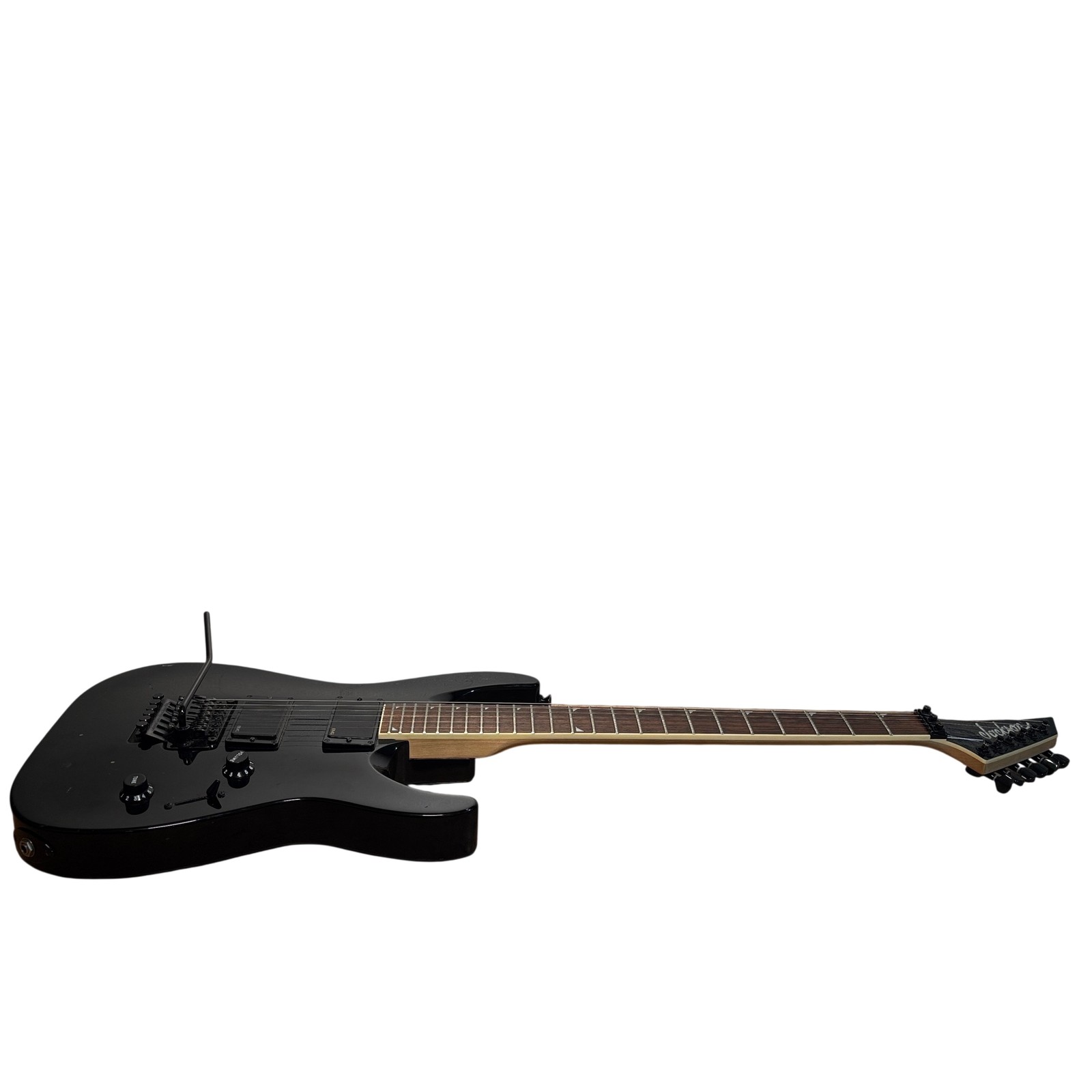 Black Jackson DKMG right-handed 6-string electric guitar with 24 fret, showing hardware and fretboard on white background.