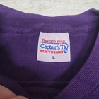 White label with blue text reading “Tennessee River Captain’s T Heavyweight L” on purple ATLANTA GEORGIA T-shirt.