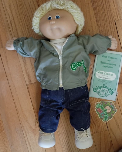Cabbage Patch Kids light skinned blonde boy doll.   Includes an original box.