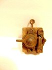 antique window sash lock mounted on old wooden back for display