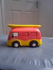 Vw Camper Van style looking Ceramic money box with Surfing board on top.