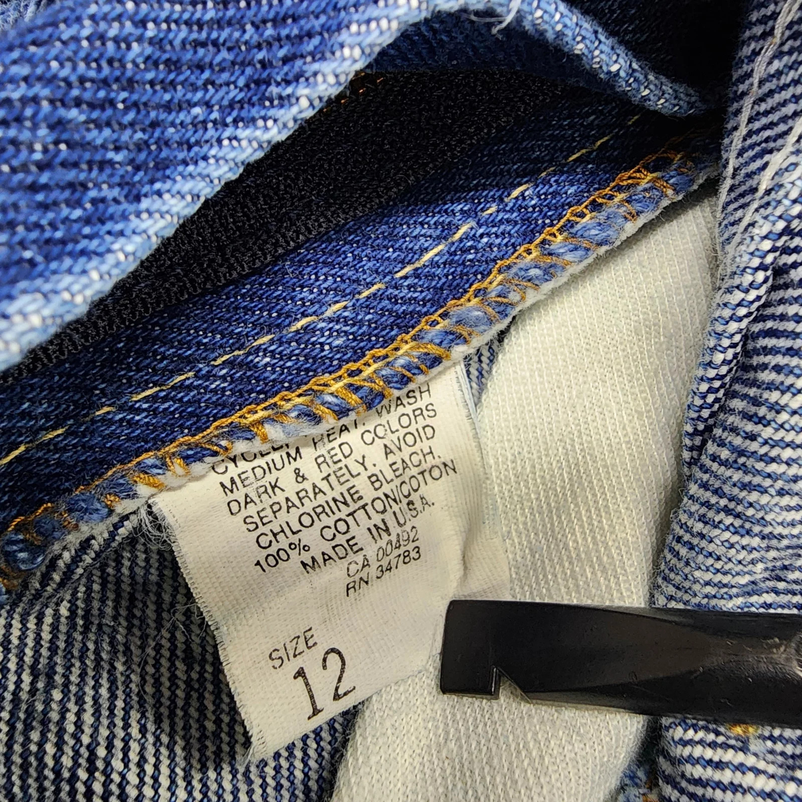 Vintage blue denim high rise straight leg Lee jeans, size 12, with white label showing care and red printed text.