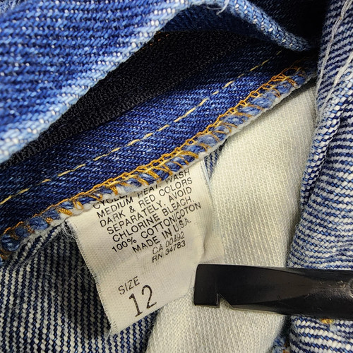 Vintage blue denim high rise straight leg Lee jeans, size 12, with white label showing care and red printed text.
