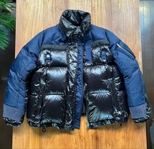USED DOWN JACKET SIMILAR TO SACAI, WITH CONTRASTING MATERIAL DESIGN. GOOD