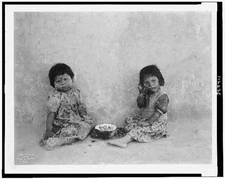 Moki melon eaters,2 Hopi Indian girls eating melon,c1900,Edward S Curtis,Photo