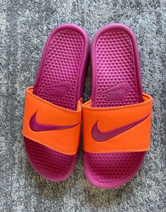 pink and orange nike slides