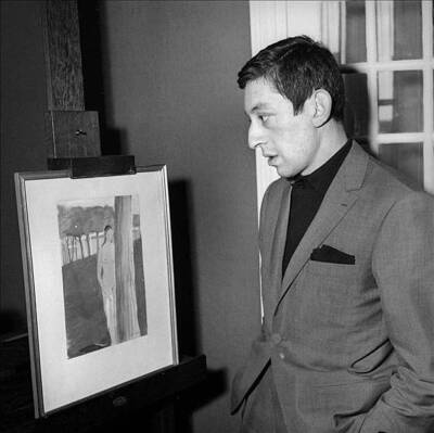 Serge Gainsbourg French singer composer looks at a painting circa - Old Photo