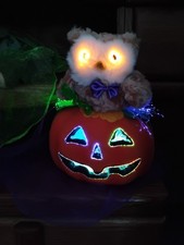 Owl With Lit Yellow Eyes Sitting On Fiber Optic Jack-o'-lantern Halloween...
