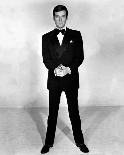 Roger Moore full body 007 in tuxedo pointing gun Live and Let Die