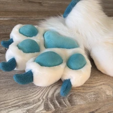 The animal's fluffy paws were made by hand.