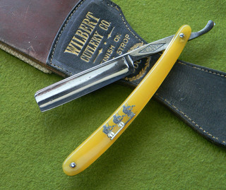 "Three Fiddlers" straight razor with deep luminescent yellow celluloid handles.