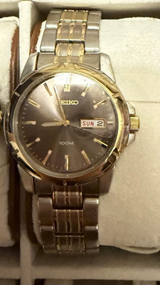 Seiko Quartz 100m Day/Date Two-Tone SS Bracelet Gray Dial Gold Fixed Bezel