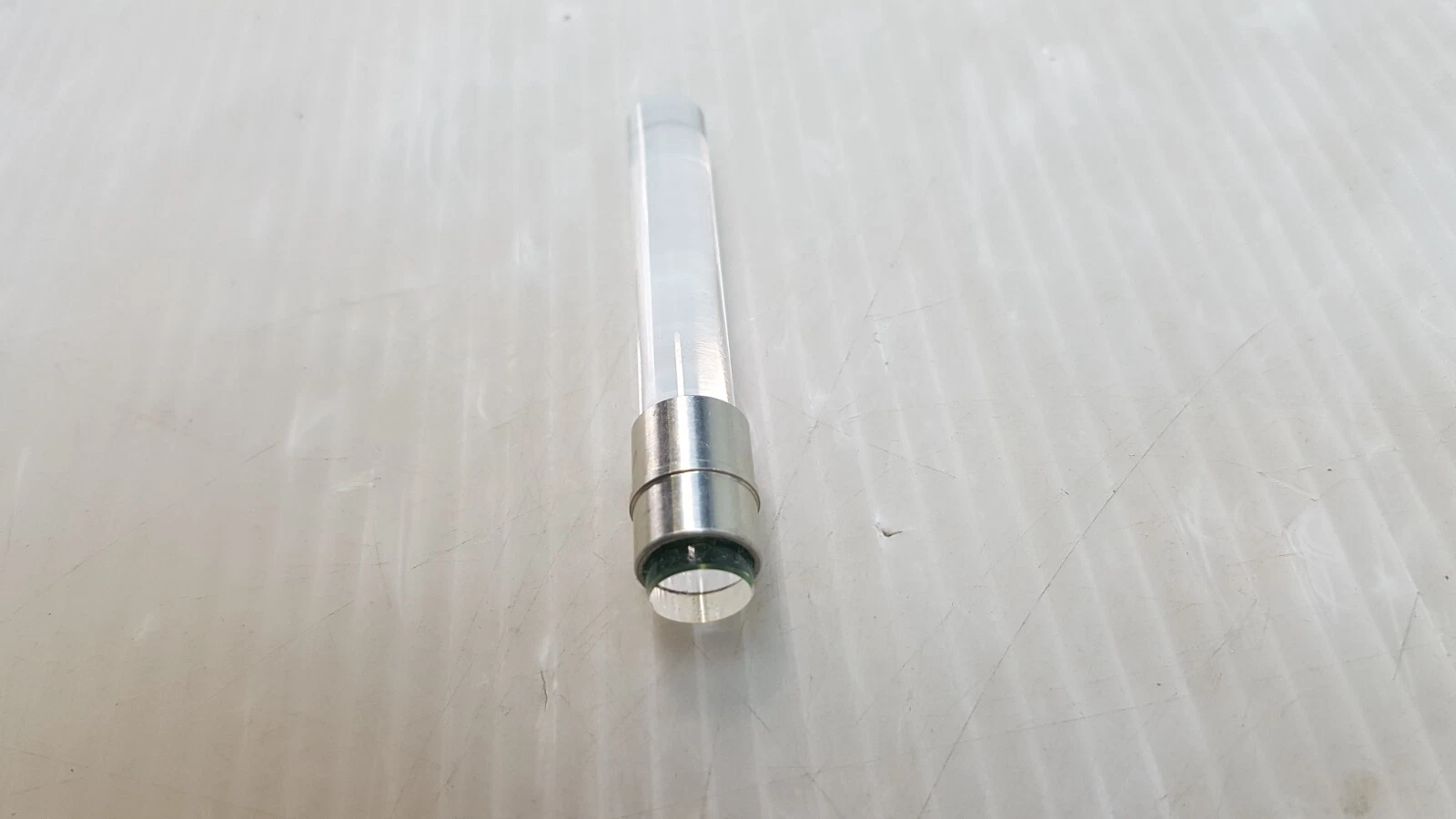Light guide standing on end, showing the polished face inside the metal sleeve