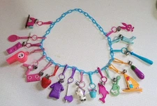 Vintage 1980s Plastic Clip On Bell Charm Necklace 18 Charms with Blue Chain