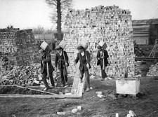 Four bricklayers at work carrying bricks in their hods - 1925 Old Photo