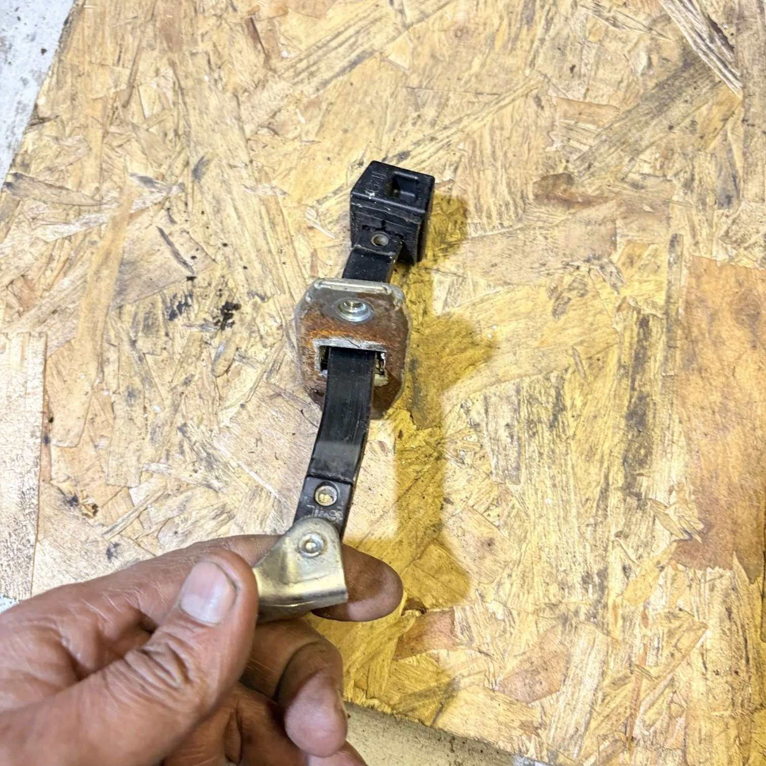 Actual rear door check strap side profile and metal mounting plate