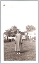 Vtg B&W Snapshot Young Woman In Graduation Gown & Mortarboard Backyard. 1940s