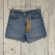 Levi s Women s High-Rise Slim Throw Hip Shorts Size 28 Medium Wash Raw Hem NWT