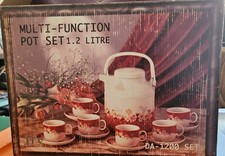 Red teapot with matching six cups and plates