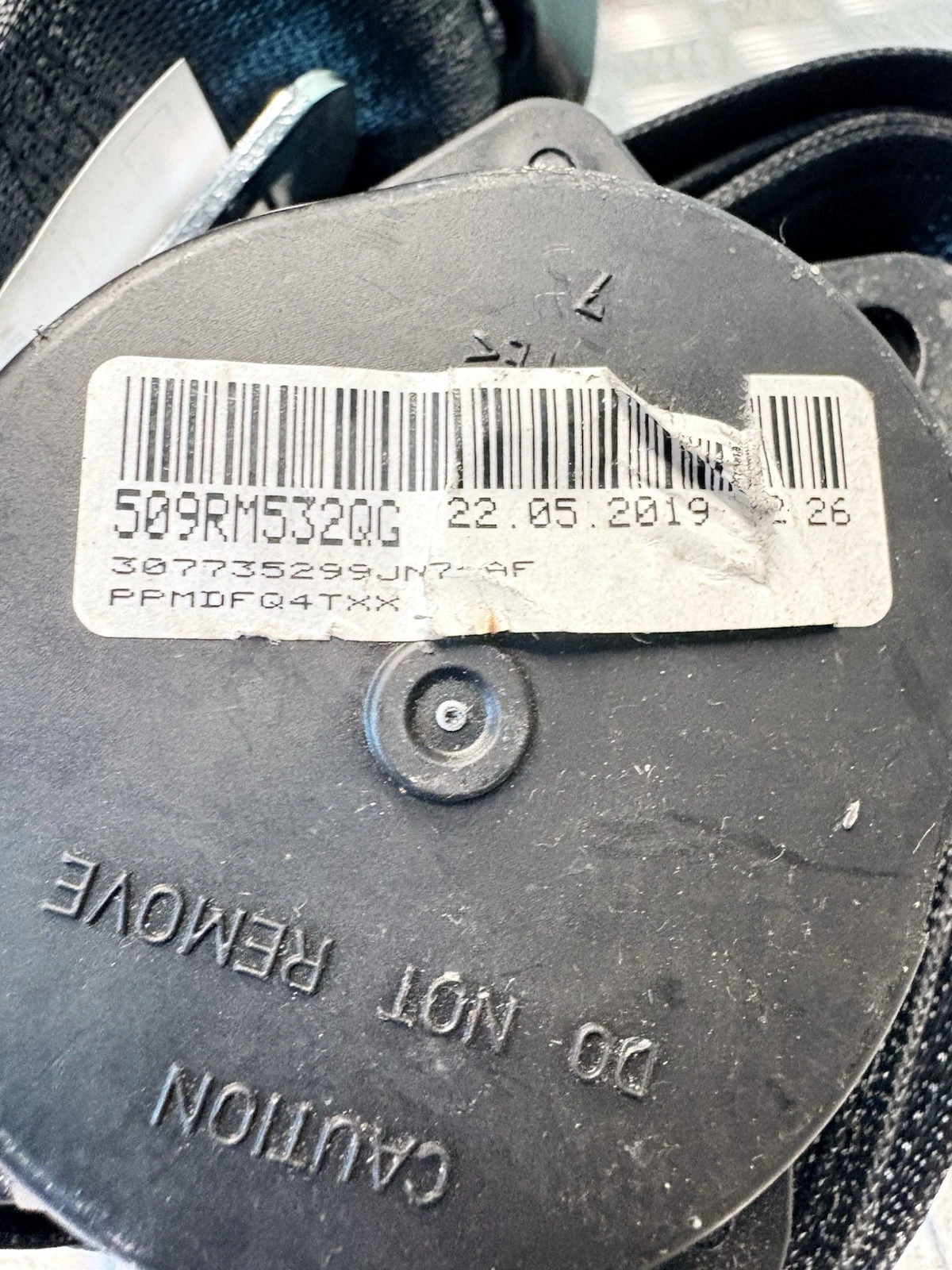 Seat belt retractor identification label and reference number