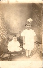 Real Photo Postcard 1910s Two Girls In White Dresses Baby In Rocking Chair