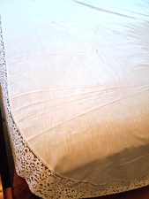 OVAL TABLECLOTH. 102" X 60" ACTUALLY 65" OFF WHITE WITH WHITE LACE.