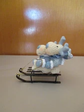 2 Sledding Moose Figures