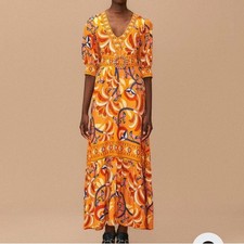 Vibrant orange maxi dress with a flattering fit, featuring a beaded belt