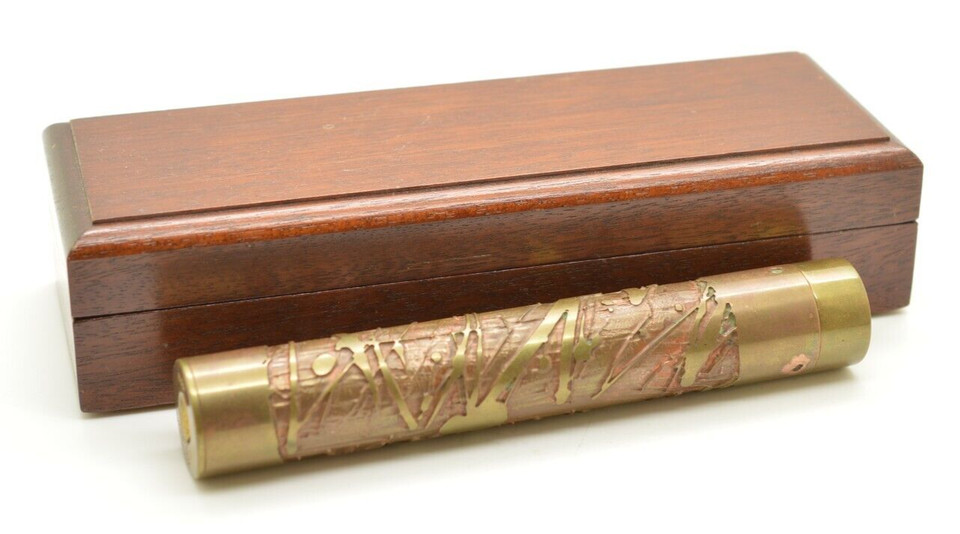 A signed, numbered (4229!) 1986 Stephen Auger ornate brass-and-copper kaleidoscope with original box — this is serious American studio art glass.