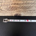 Vintage Stanley 50 foot hand crank tape measure with black and red vertical scale marked in feet and inches, made in USA.