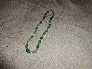 turquoise colored plastic and faux pearl necklace. unbranded. 22 inches long