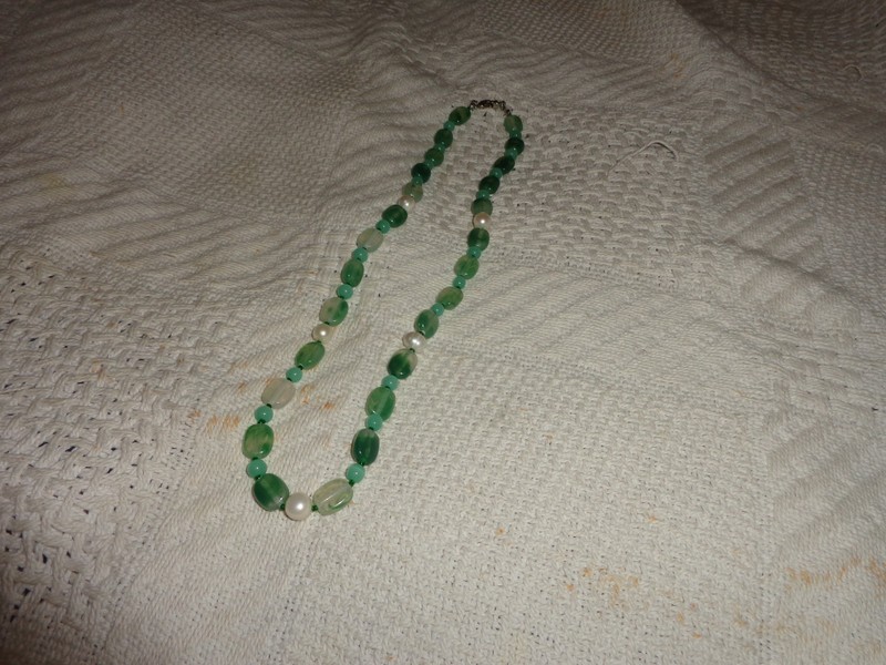 turquoise colored plastic and faux pearl necklace. unbranded. 22 inches long