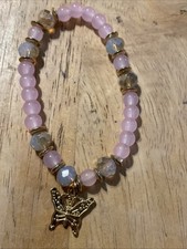 Butterfly stretchy beaded bracelet featuring translucent pink beads