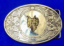 Vintage western two tone Horse saddle on ornate oval belt buckle.