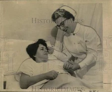 1962 Press Photo Nurse Comforts Theresa Di Pascal, Beating Victim - now57218