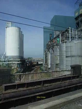 Photo 6x4 Railway line between Unilever storage tanks at Warrington As se c2010