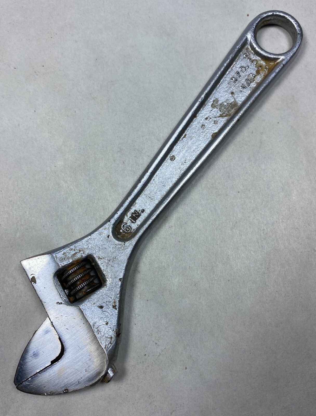 Silver 6-inch adjustable crescent wrench with worn handle, engraved “706,” and “Made in U.S.A.” on metal plate.