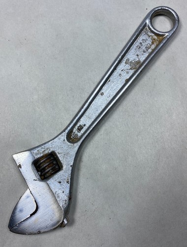 Silver 6-inch adjustable crescent wrench with worn handle, engraved “706,” and “Made in U.S.A.” on metal plate.