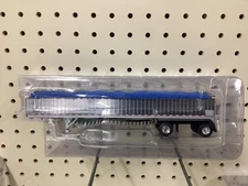 1/64 DCP Wilson 50' Patriot Spread-Axel Chrome Belt Trailer with blue Tarp