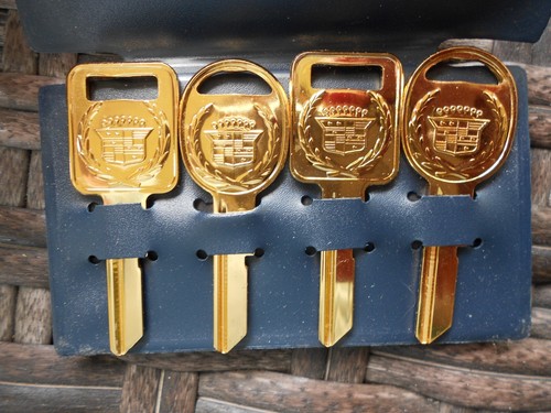 GM CADILLAC CREST GOLD C+D NOS KEY BLANKS WITH FACTORY BLUE SLEEVE