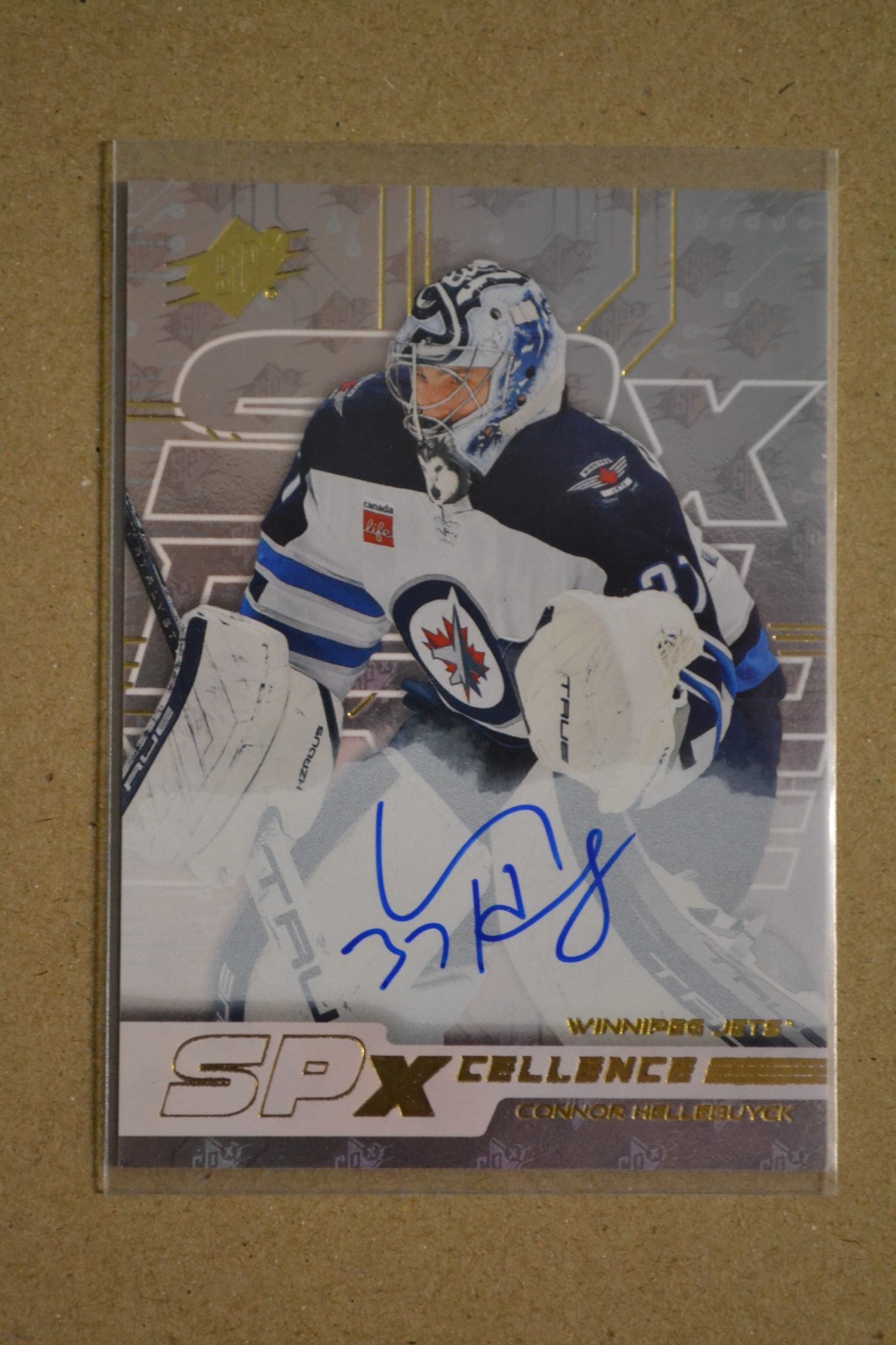 2024-25 SPx - SP Xcellence Gold Auto /99   Connor Hellebuyck #XC-CH