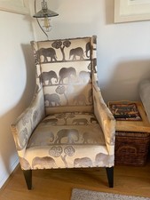 Timothy Oulton ‘manor ‘design armchair in an unusual elephant design fabric .