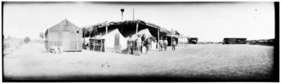 men standing under a makeshift shelter in the Imperial Valley Cali - Old Photo