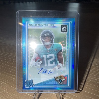 2025 Optic - Travis Hunter #201 Neon Blue Prizm Autographs 175/299 (AU, RC)