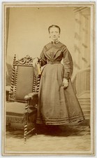 WOMAN POSED STANDING AT CHAIR, HOLDING BOOK. TINTED CDV. ALLEGHENY, PA.