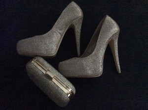 gold heels and clutch bag
