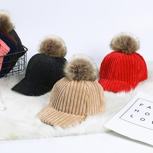 baseball hat with fur ball