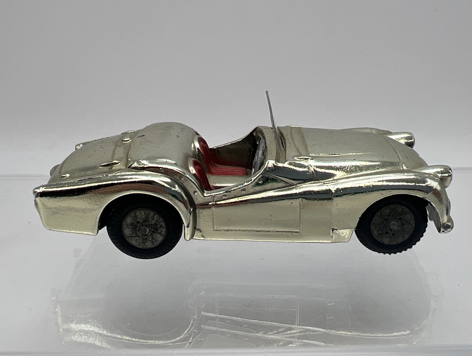 A Corgi Toys 301 Triumph TR2 Sports Car, cream body, red seats, flat
