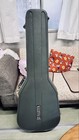Black Martin D-76 acoustic guitar with hard shell case, silver hardware, and ornate “Martin D-76 Limited Edition” sticker.